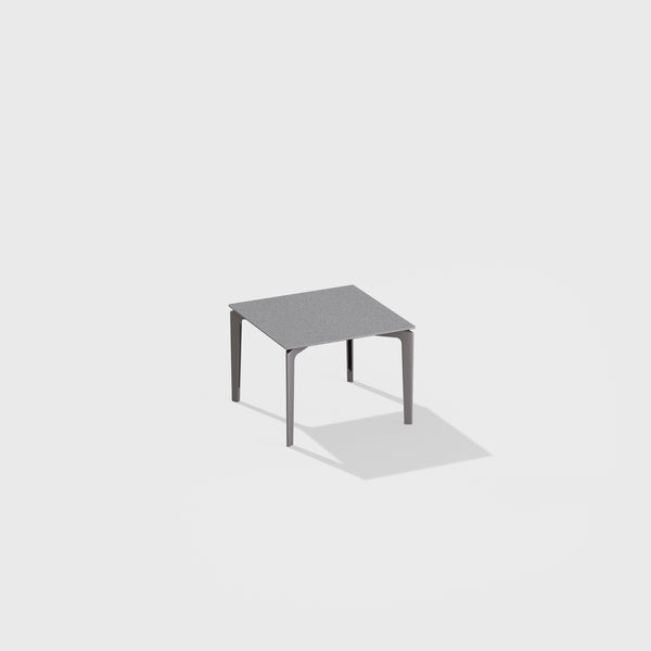Low square table with top in speckled aluminium